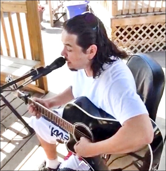 Aaron Arcand performs at the Territorial Drive Farmers Market.