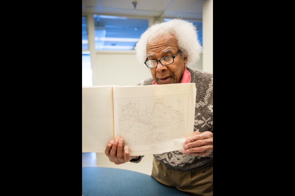 Dr. Jim Christopher holds up a copy of his original report on the Saskatchewan Bakken, from 1961.