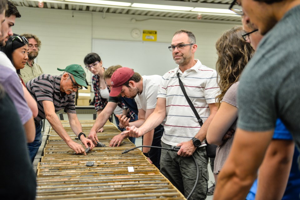 Dr. Colin Card, in white on the right, shows different core characteristics to SGS staff and summer students on June 7.