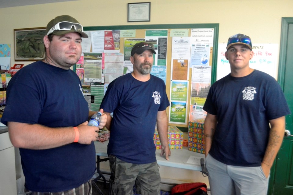 (L-R) Taylor Hoey, Ron Thompson, Brock Andrews of the Carlyle fire department getting ready for the fundraiser golf game