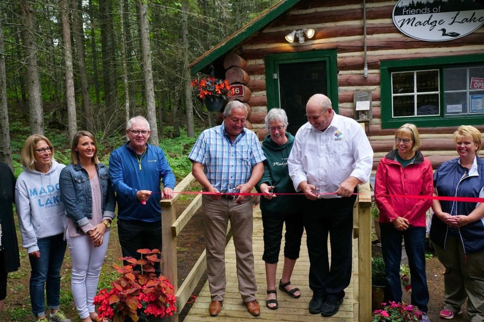 A ribbon cutting ceremony was held at the cabin known as Friends of Madge Lake. From left, were: Gillian Culham; Steph Hudy; Kim Schindler; Terry Dennis, Canora-Pelly MLA; Nancy Welykholowa; Greg Podovinnikoff, Park manager; Leesa Haslund, and Lisa Placatka.