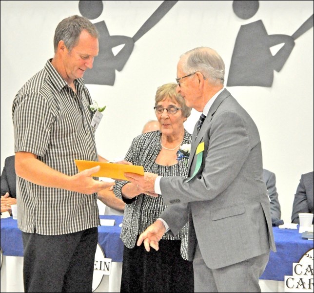 President Jane Shury and board member Don Macdonald present the inductees with Saskatchewan Baseball Hall of Fame induction plaques. Bye Braun of Cut Knife accepts his plaque. Photos by John Cairns