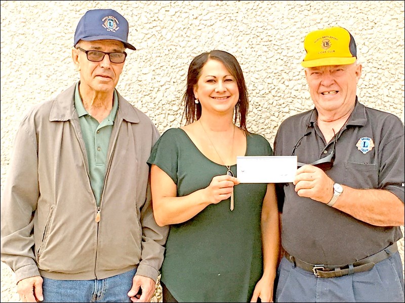 Lions Draw — The North Battleford Lions Club held a draw at Territorial Days. The first prize worth $1,000 went to Waverley Falcon. She receives her prize from president Terry Melnechuk on the left and chairman Gordon Mullett on the right.