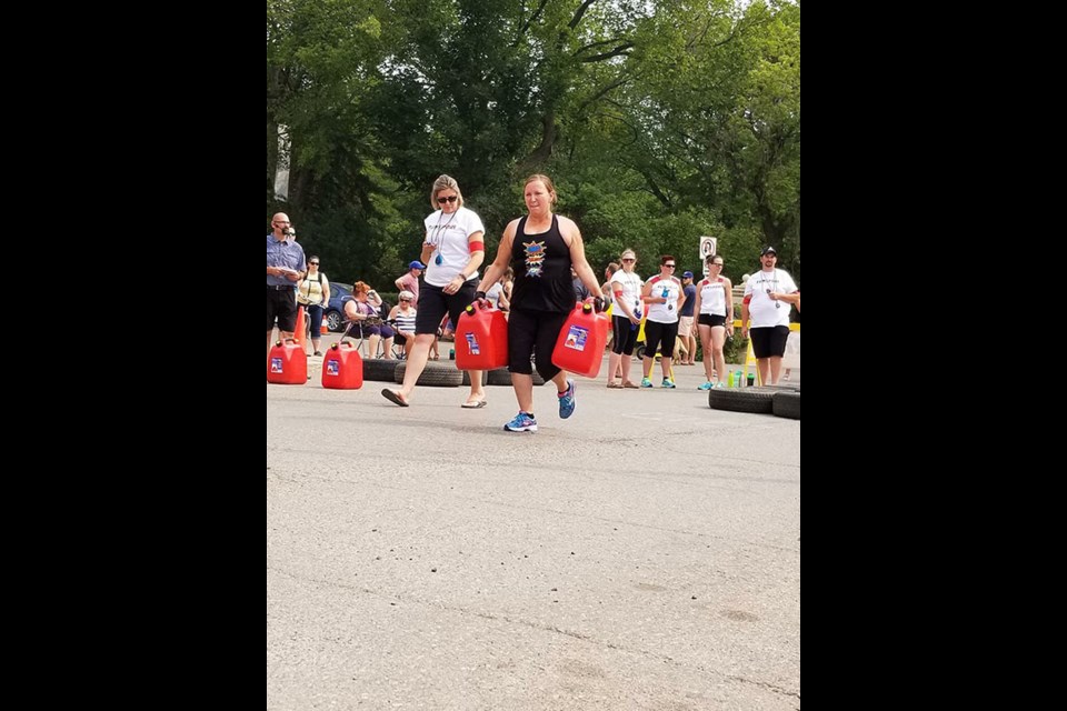 Tessa Young carries gas cans as part of one of the physical challenges. Photo submitted