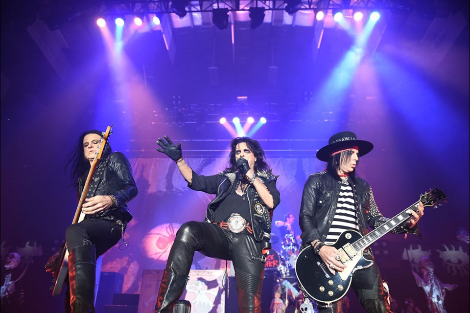 Alice Cooper, centre, stands next to band mates Chuck Garric, left, and Tommy Henriksen, right. Henriksen is renowned as an extraordinarily gifted producer and songwriter, and Garric is known for his long time involvement with Cooper, and his time spent playing bass with Ronnie James DIO.
