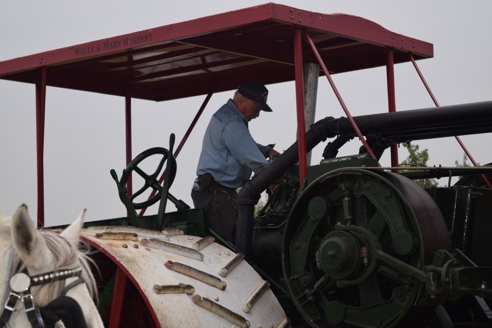 After working on the restoration of the Rumely tractor, Doug Ireland of Binscarth, Man., helped get it started and made sure all the necessary adjustments were made for the threshing demonstration.