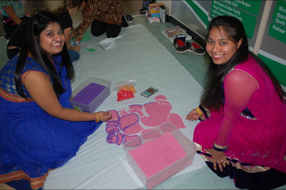 Swati Sharma, left, and Khushali Raval of the Arcola East Bhangra group provided some additional fun for youngsters, teaching them some traditional artistic drawings as well as providing some henna tattoos for young and old alike during Cultural Collage at the leisure centre in 2016. File photo.
