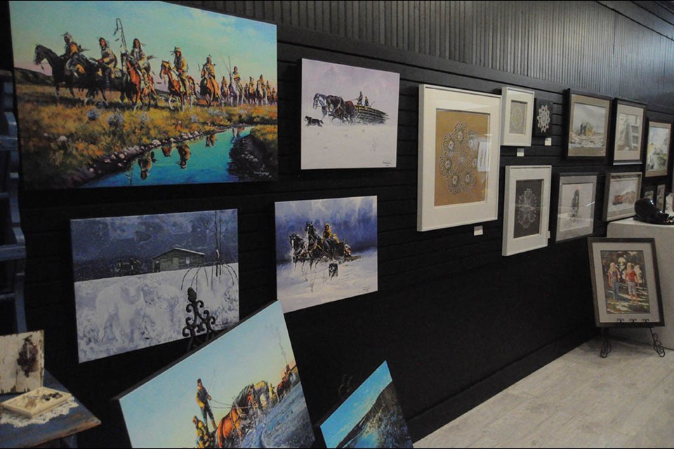 An exhibit of the works of artist Michael Lonechild drew a number of people to Art Concepts in Estevan last week. Photo by Corey Atkinson.