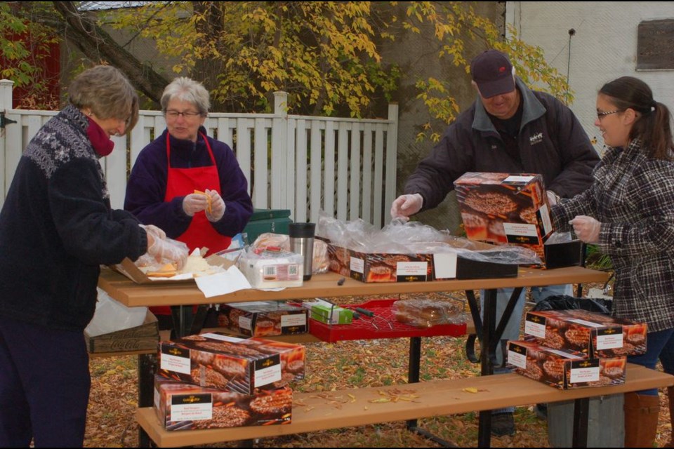 Sturgis Station House Museum volunteers helping to prepare hamburgers during the Co-op barbeque held in Sturgis on September 18. From left, were: Greta German, Myrtle Boychuk, Bob Knutson and Kim Rose.