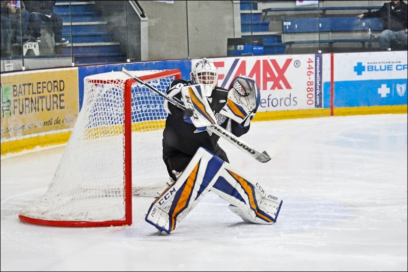 Joel Grzybowski handles a high shot in the first period. Photos by Josh Greschner