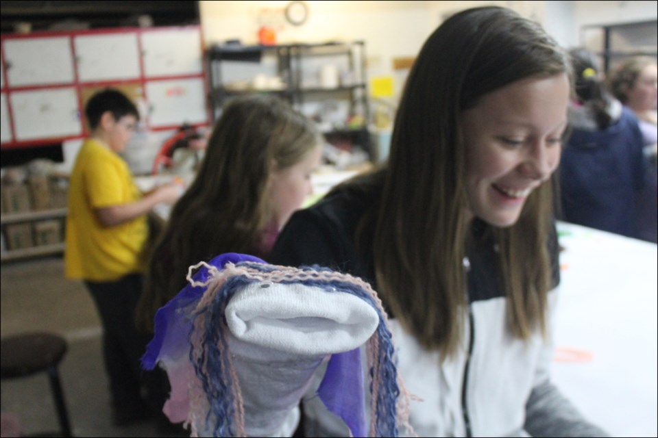 Keira Wood shows off her creation at a sock puppet making workshop at the Flin Flon Pottery Club on Sept. 28. - PHOTO BY ERIC WESTHAVER