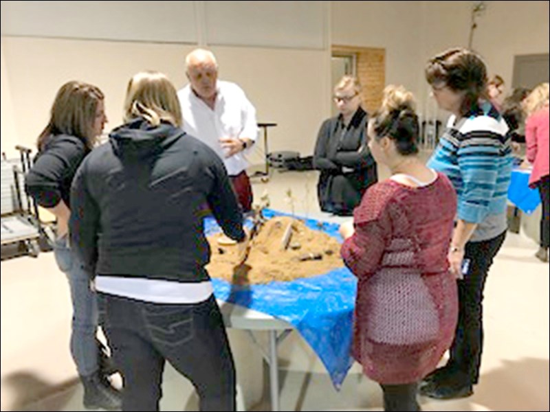 The BECIP team plays and works together on designing a miniature natural playground.