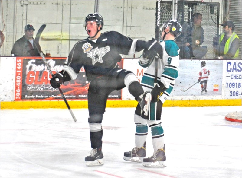 Brett Gammer shoves off the competition as he celebrates his third goal of the season Friday night. Gammer's goal gave the North Stars a 4-2 lead while teammates joined in the scoring to give the North Stars a decisive 8-4 lead at the end of the second period.