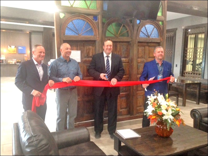 Mayor Ryan Bater cuts the ribbon at Comfort Inn and Suites’ grand opening last Thursday in North Battleford.  Photos by John Cairns