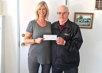 Ag Society Upgrade — Gordon Mullett, representing the North Battleford Lions Club, presents a $5,400 donation to Jocelyn Richie of the Battlefords Ag Society. The donation will support expansion of the Agriplex kitchen and painting of the facility. Photo submitted