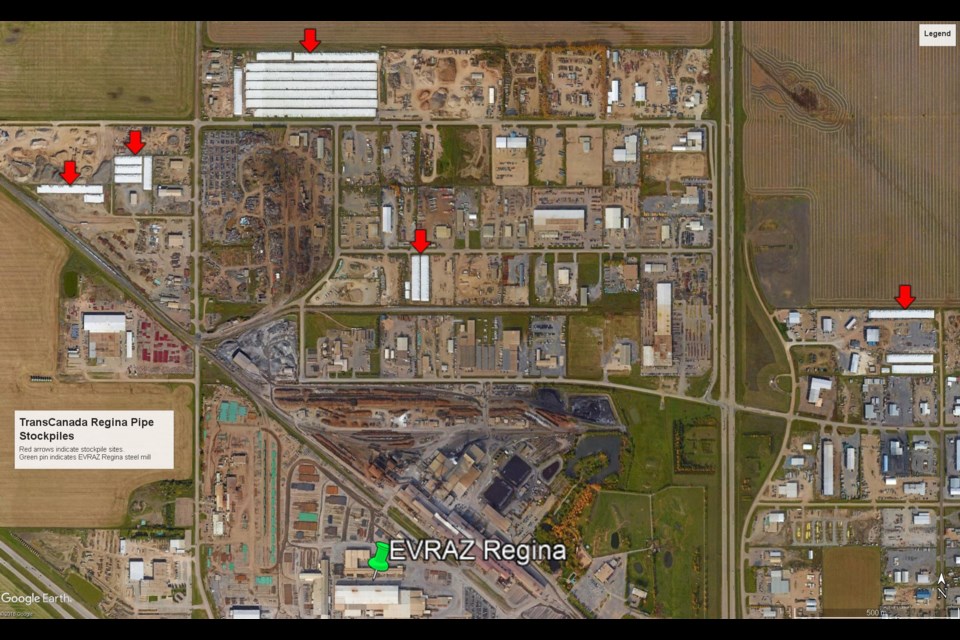 This map from Google Earth shows five stockpiles sites for pipe that had been destined for Keystone XL. The red arrows indicate stockpiled pile, painted white. The green pin indicates the EVRAZ Regina steel mill. To the left of the steel mill is fresh, green pipe, the usual colour after pipe has been coated