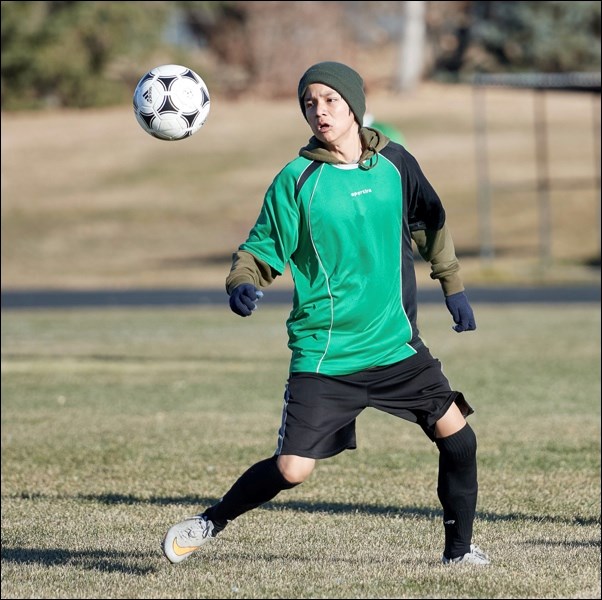 This is action from Centennial Park as Chief Poundmaker School/Little Pine hosted the 2A boys provincial soccer championship. Aeydon Bull of the Chief Pundmaker-Little Pine team keeps his eyes on the ball. Photos by Averil Hall