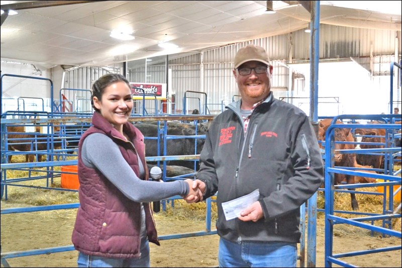 Mitch Stuart, president of the Fall Fair Committee, presented Laura Carruthers of Frenchman Butte with $1,250 as part of the Fall Fair 4 -H program. Photos by Brenda Pollard