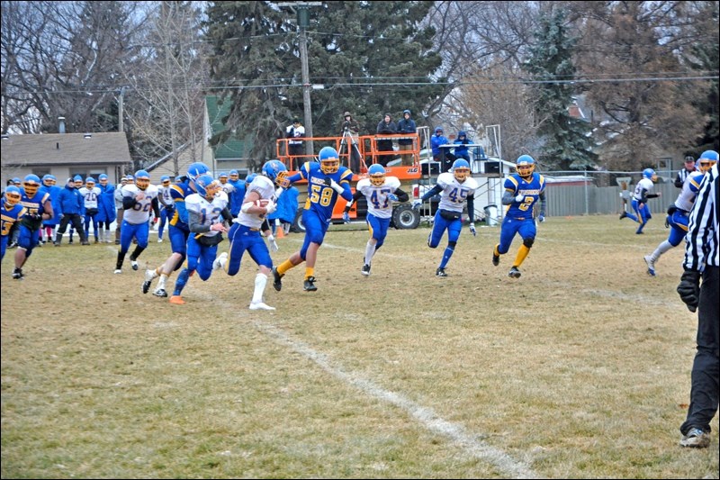 This is action from Saturday afternoon at Crusader Field, as Humboldt, in white, took on the John Paul II Crusaders, in blue, in 3A playoff semifinal action. Humboldt ended up victorious 23-15. Photos by John Cairns