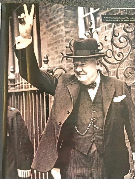 Winston Churchill flashing his famous V for victory sign.