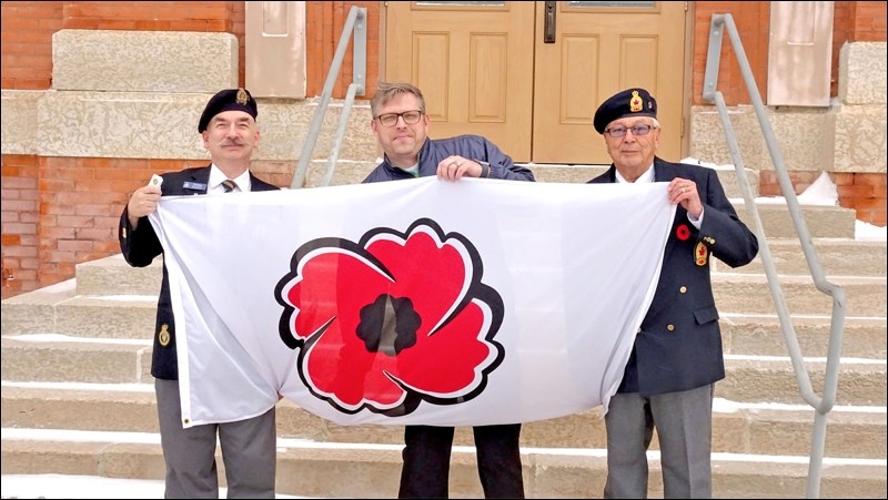 Members of Royal Canadian Legion Branch #9 Battleford met with the mayor Monday morning to raise a flag in honour of Remembrance Day. Pictured are Legion member Ron Falcon, Mayor Ames Leslie, and First Vice-President Tim Popp. Photo by Noreen Hoffart