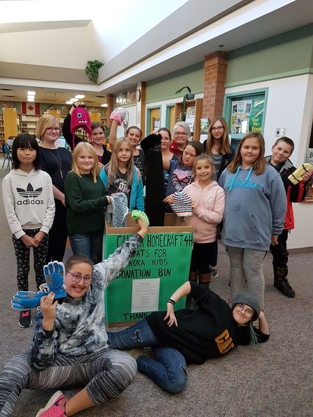 The Canora Homecraft 4-H Club has started a Coats for Kids campaign to help Canora and area children stay warm through the upcoming winter. Club members recently visited the Canora Public Library, one of the locations accepting winter clothing donations for the campaign. From left, are: (back row) Brooklyn Reine, Mary Bakke, Jania Predinchuk, Joanne Babb, Deb Leson (librarian), Tessa Spokes, Jesse Shannon, (middle) Vicky Lei, Brenna Reine, Reagan Goetzinger, Heidi Parmley, Rhianna Stefanyshyn and Natalie Kosar and (front) Zennia Lukey and Daylia Lukey.