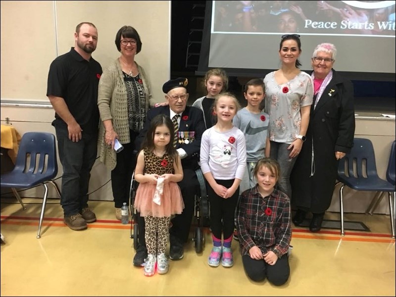 Elmer Hall, veteran of World War 2, was invited to the EMBM School in North Battleford for Remembrance Day festivities with the children. He spoke to them about the war and the older children had a question period, answering questions they had about the war. They were pleased to have him join them and talk to them on Nov. 8. Some of his great-grandchildren read stories he had told them earlier. Seated is Elmer Hall, the adults standing are, left to right, Ryan Shepherd, his mother Colleen, Rhonda Kauth and her grandmother Germaine Hall. The children, left to right, are Kali Kauth, Mikayla and Isabel Shepherd, Kruz Kauth and Hannah Shepherd in front. Photo submitted by Lorna Pearson