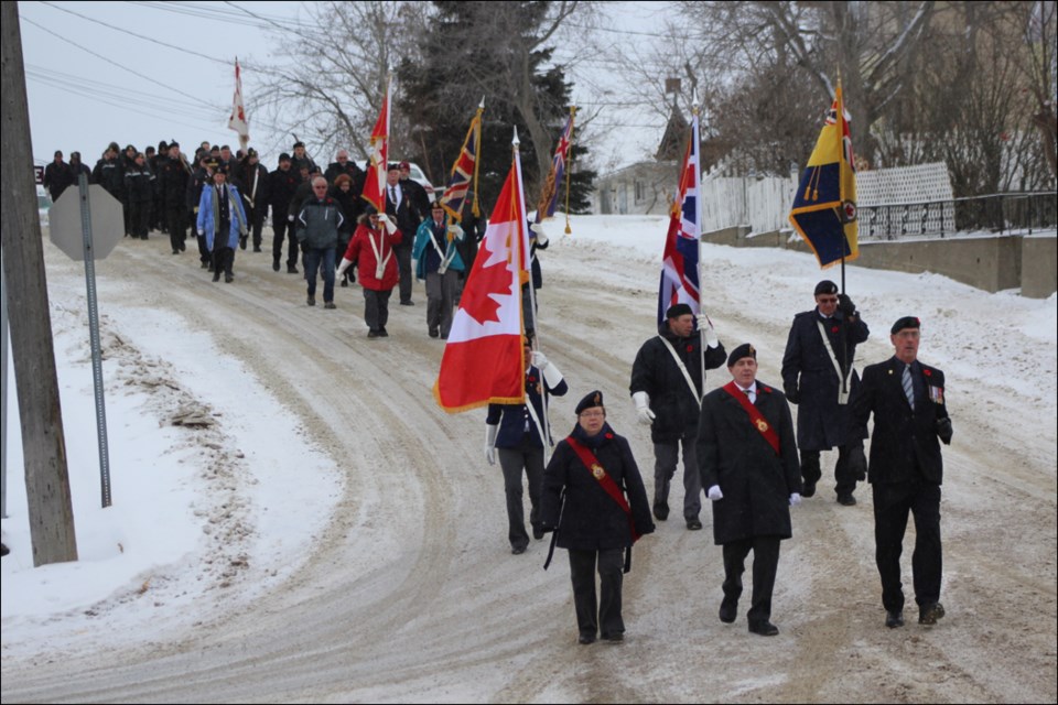 The Remembrance Day parade heads down Hill Street on its way to the Flin Flon Community Hall.