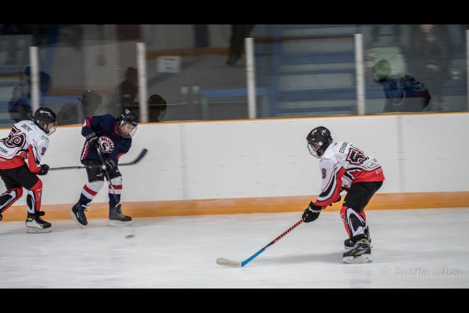Robbie Grieve of the Kamsack Peewee Flyers tried to stop a Melville Player while Levi Erhardt intercepted a Melville pass in Kamsack on November 10. Photo credit: Dustin Wilson