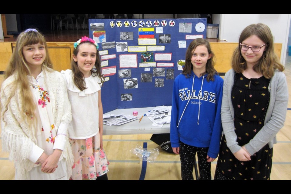 Becky Klop, Abby Calvin, Leah Fraser and Mikayla Gonder with their display on Venezuela.