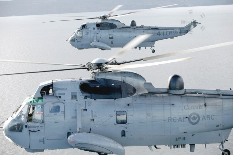 Two Sea Kings from 443 Marine Helicopter Squadron fly over the Strait of Georgia last week.