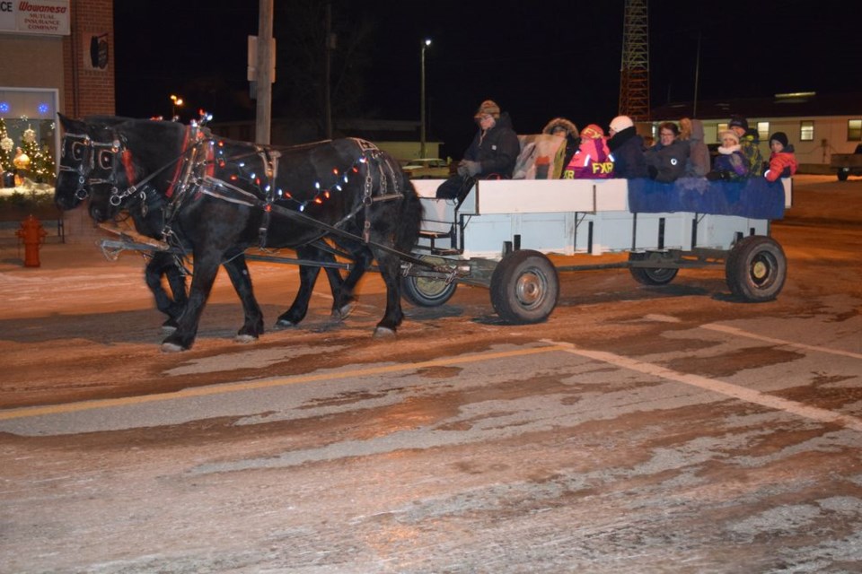 Lloyd Smith of Pelly and his black Percheron horses Tom and Jiggs provided sleigh rides to riders of all ages in Canora on November 26 as part of the Winter Lights Festival. The rides started and ended at the Canora Visitor’s Centre/CN museum, with Smith’s granddaughter Morgan Wallington taking over and driving the team occasionally throughout the evening.