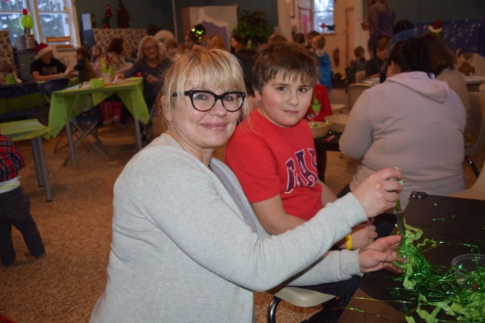 Everyone at Grinchmas in Canora, including Emmitt Demchuk and his mother Anita, had the opportunity to fill a clear plastic tree ornament with their choice of three different types of fill, add a red glitter heart, put on a pipe cleaner hanger and take it home to add to their own Christmas tree.