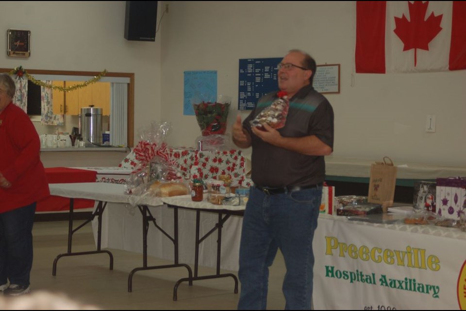 Sheldon Luciw auctioned the first item at the Preeceville Hospital auxiliary Christmas auction.