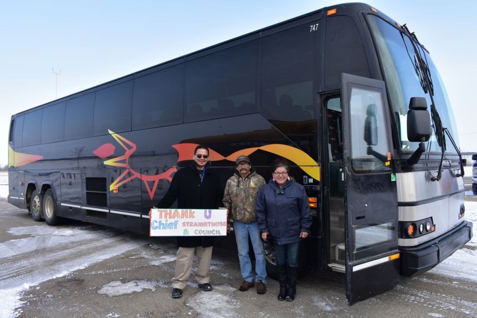 Lee Ketchemonia (teacher) held up a sign thanking Chief Straightnose and council for their part in helping to make the new coach bus a reality for Keeseekoose First Nation. With him were Fred Cote (bus driver) and Shawn Kakakaway (Saulteaux teacher.)