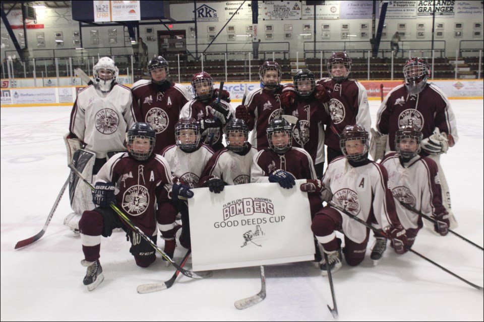 Members of the Flin Flon peewee AA Bombers hold up a banner for their entry to this year’s Chevrolet Good Deeds Cup. - PHOTO BY ERIC WESTHAVER