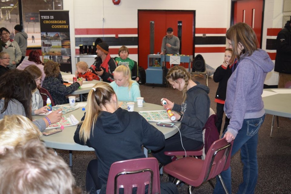 Aaron Herriges, director of leisure services, and Crossroads Credit Union staff members organized and called the games during Teen Bingo.