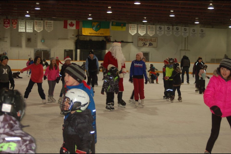 Santa was swarmed by children and adults when he took to the ice for a skate at the Skate with Santa evening in Preeceville.