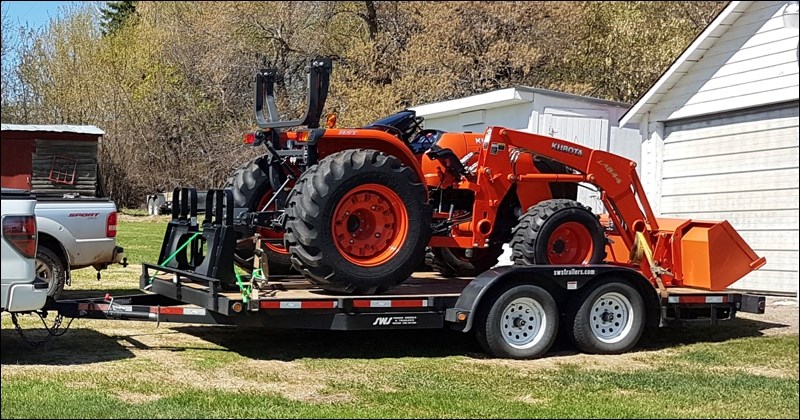 A black car hauler trailer with Alberta plate 5AY 209 has been stolen from a rural property north of Wilkie. Also stolen is an orange 2013 Kubota MX-5100 tractor with a 60" Blue Diamond rock bucket Bobcat attachment.