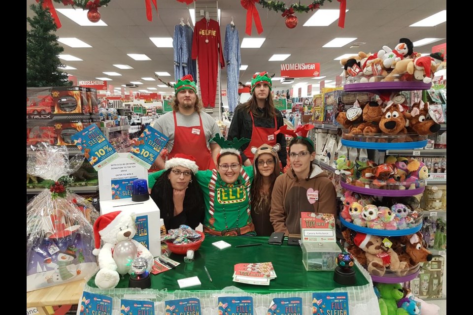 As part of the Canora Ambulance Yuletide Toy Drive, The Bargain Shop in Canora hosted Fill the Sleigh Day on December 8. From left, were: (back row) Dylan Wiley and Jeff Simoneau of The Bargain Shop, and (front) Jocelyne Weinbender, Canora Ambulance; Zennia Lukey, helper elf, and Karleen Rubletz and Alyssa Lukey of The Bargain Shop.