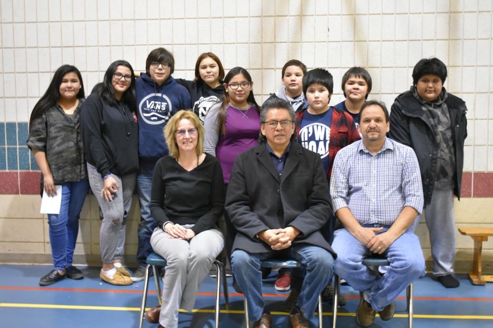 Students who participated in the N’we Jinan music video project at the Chief Gabriel Cote Education Complex, and were part of the video release celebration at the school on December 13, from left, were: (back) Jasmine Kakakaway, Veronica Tourangeau, Sean Kakakaway, Lori Anne Brass, Kalista Kakakaway, Cole Kakakaway, Trenton Keshane, Tian Papequash and Mikhye Tourangeau, and with them, (front) Janet Love Morrison (teacher), Chief George Cote of Cote First Nation and Jonas Cote (principal and emcee for the program.)