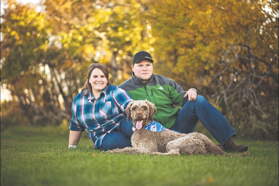 Brittany Fox, pictured here with her partner Damon Sutherland and their dog Charlie, is looking forward to being part of the Prairie Women on Snowmobiles Mission 2019. Photo submitted