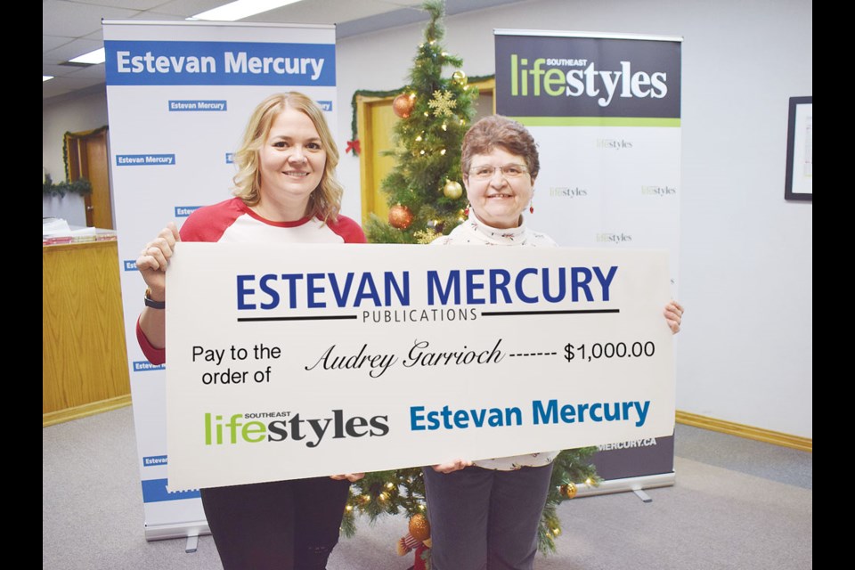 Estevan Mercury Publications sales manager Deanna Tarnes presented the grand prize cheque for $1,000 to Audrey Garrioch.