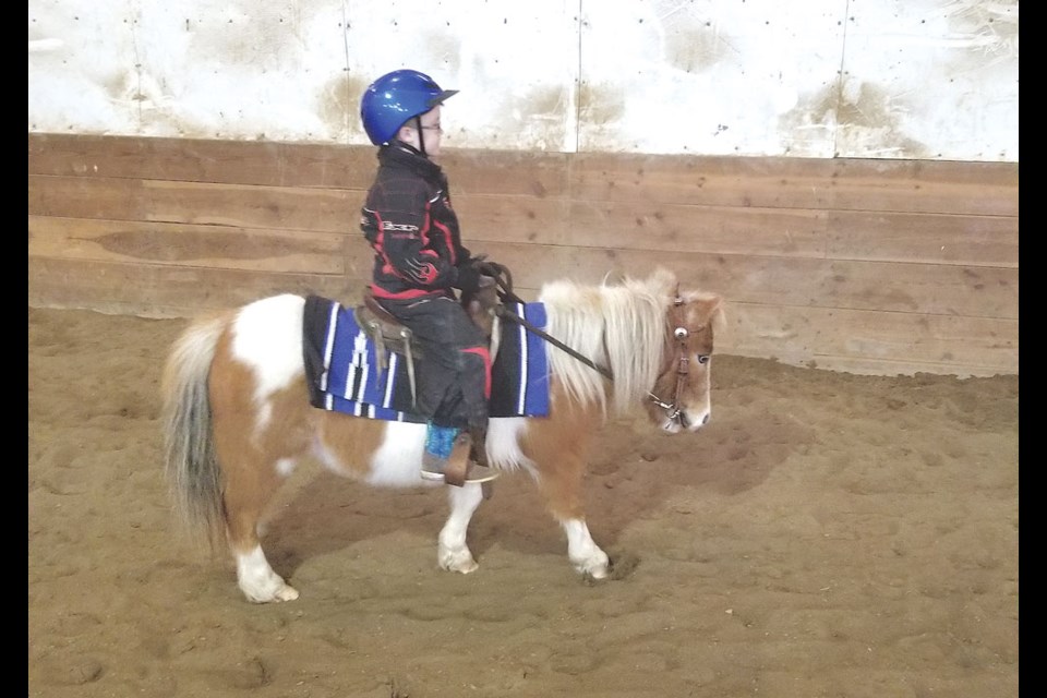 Kayden Fleury rides his miniature pony during a recent activity. Photo submitted