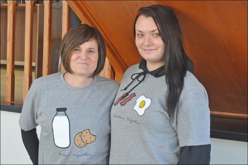 Pastor Deb McNabb and JP II student Allysa Woodrow have teamed up to bring students and seniors together as part of the Better Together program. McNabb and Woodrow wear shirts associated with the project. They hope to decrease loneliness and increase social cohesion among participants