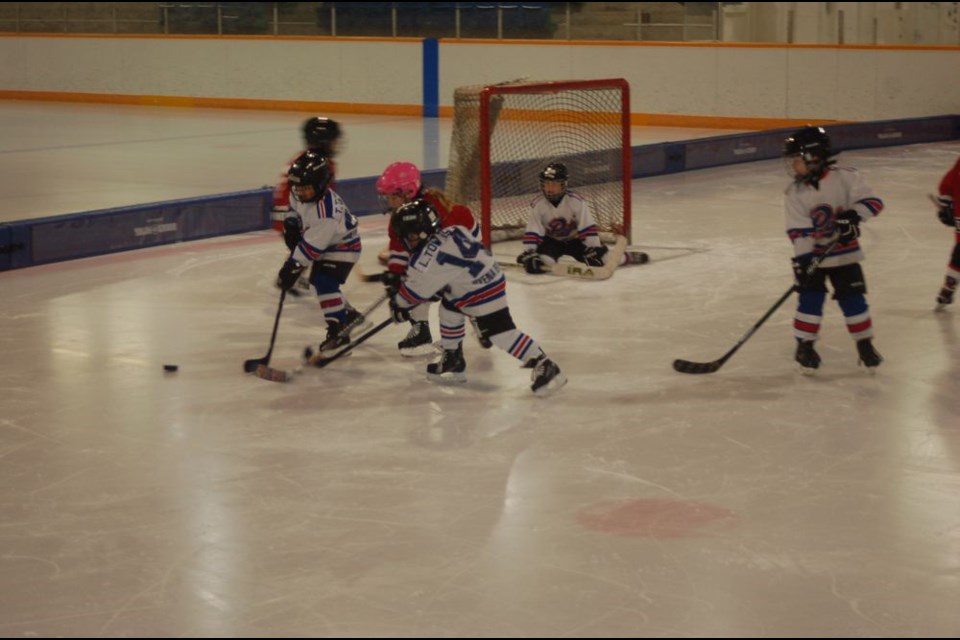 Preeceville players battling for the puck at centre ice from left, were: Dillon Serdachny, Bennett Halkyard and Chase Danielson. (white jerseys.)