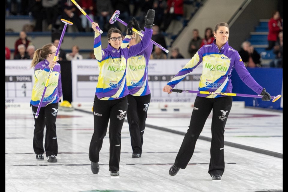 Team Silvernagle raise their broom to the home town crowd after being eliminated in the quarter finals .