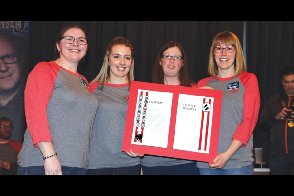 St. Brieux Kin club secretary Arien Ferre, president Chelsea Godart, co-treasurer Elise Hanck and vice-president Angie Stevenson pose with their new charter, a document that shows they are officially a Kin club. Not present was co-treasurer Andrea Pomedli. Photo by Devan C. Tasa