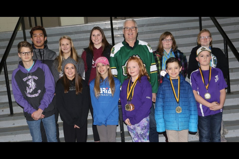 Athletes that won a provincial title or placed nationally in 2018 were recognized. From left, starting from the back, are Gabe Babagonio, Kiana Leicht, Lauren Hinz, Mayor Rob Muench, Tia Zimmerman and Samantha Fisher. In front are Darren Romanuik, Raya Wacker, Marie Millette, Abbey McLarty, Reed Cropper and Cohen Gasper. Photo by Devan C. Tasa