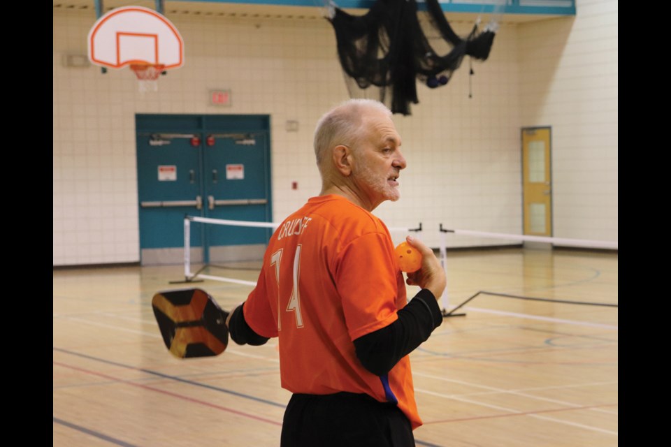 Instructor David Weiman demonstrates the finer points of correct positioning for a serve.